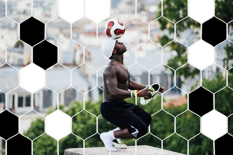 Iya Traore, a former professional football player, balances a football on his head as he performs for visitors in the Montmartre area of Paris.